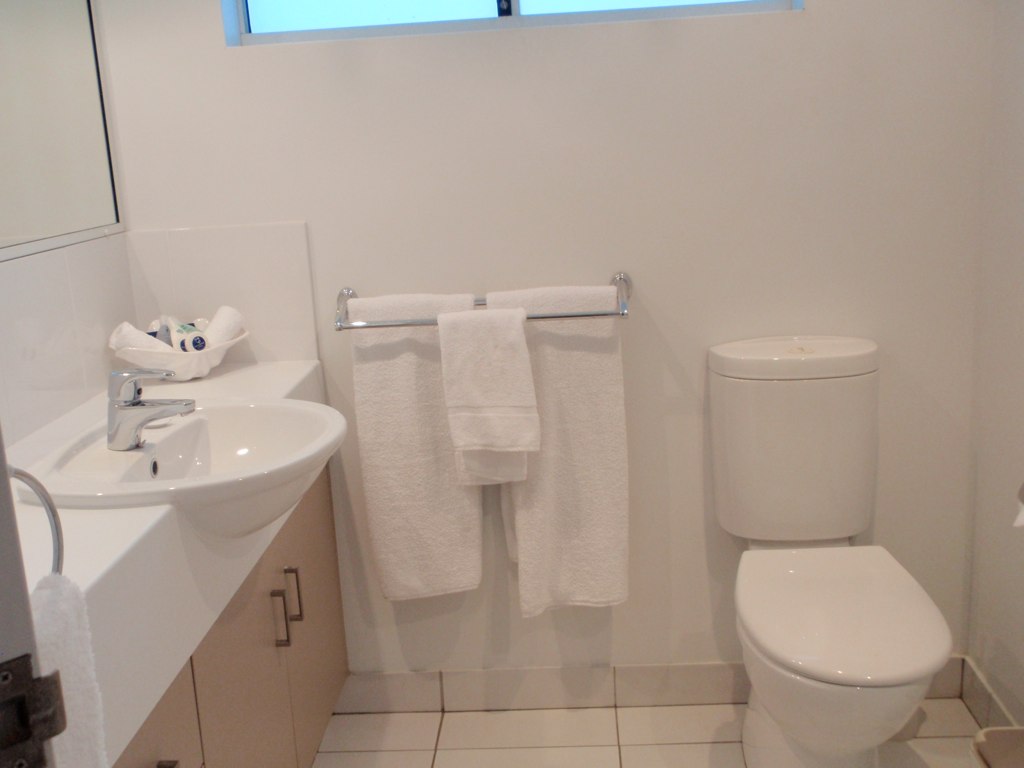 Sparkling clean white toilet and bathroom after post-HIP cleaning